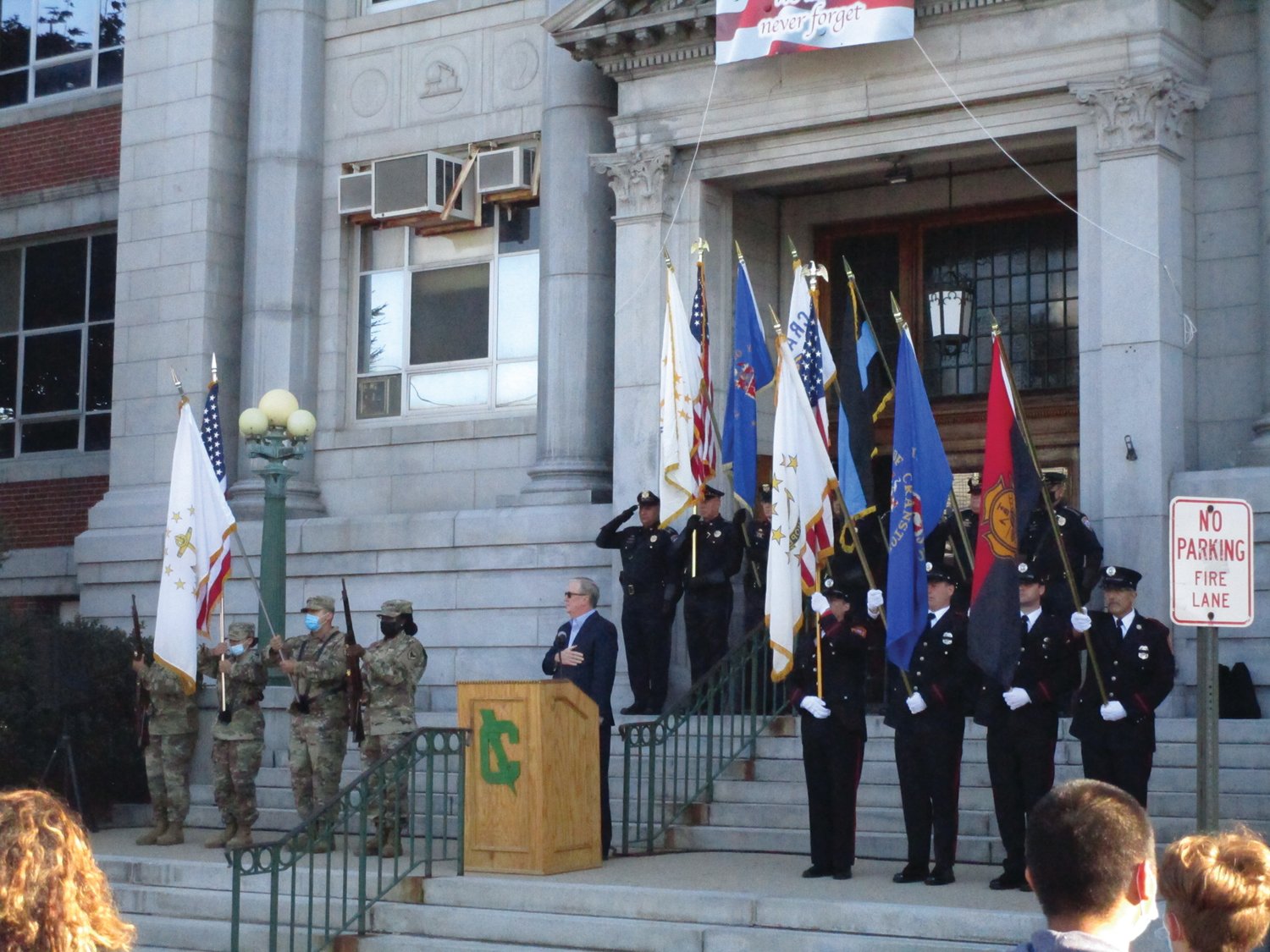 PRESENTING THE COLORS:The Cranston East JROTC, Police and Fire color guards stand on the steps of the school during Saturday's ceremony as Mayor Ken Hopkins looks on.